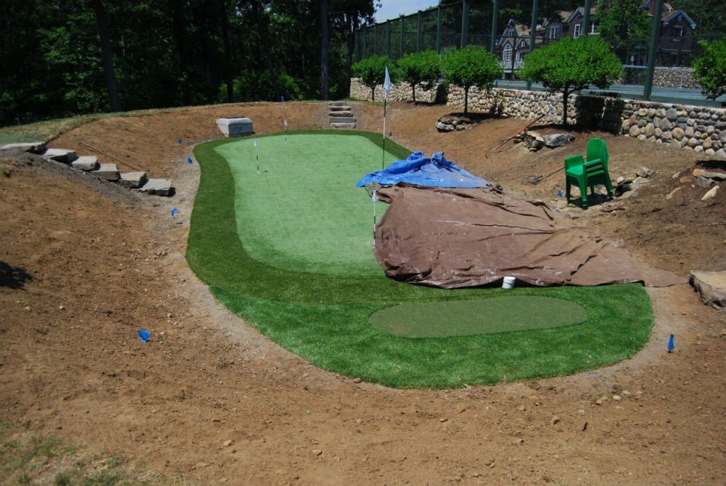 putting green installation by tennis court on organically landscaped property waccabuc westchester county ny