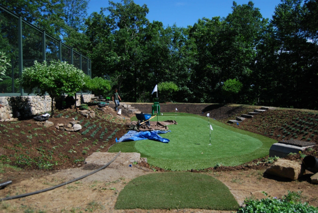 putting green installation by tennis court on organically landscaped property waccabuc westchester county ny